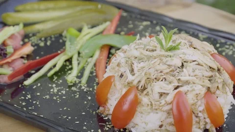 Chicken, rice and vegetables rotating on plate. Stock Footage 79473673