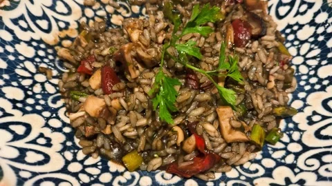 Chicken risotto cooked in white wine with onions, parmesan and fresh herbs. Stockbeeldmateriaal 332597525