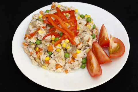 Chicken risotto on a plate dark background Fotos Stock