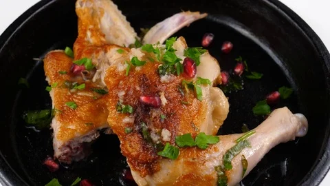 Chicken roasted in pan, served with pomegranate grains and spices Stock Footage 83165401