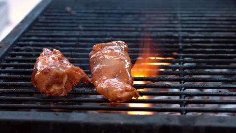 Chicken roasting on the barbeque with flames Stock Footage 75250094