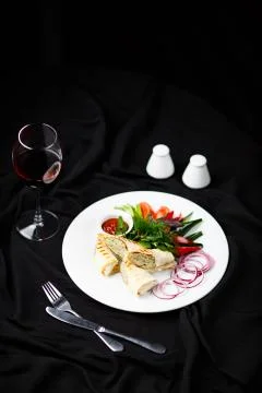 Chicken rolls on white plate Stock Photos