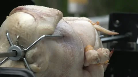 Chicken rotating on barbecue spit Stock Footage 20794259