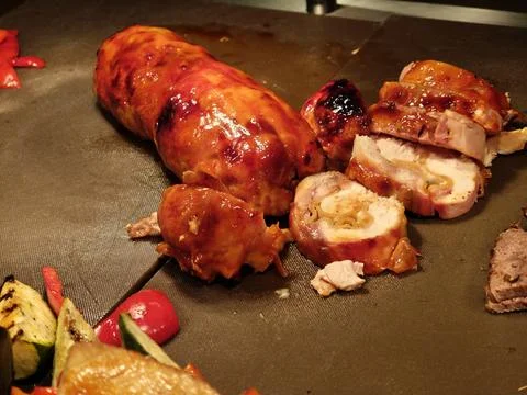 Chicken Roulade, Roasted Corn and Hotel Buffet Display with BBQ Specialties Stock Photos