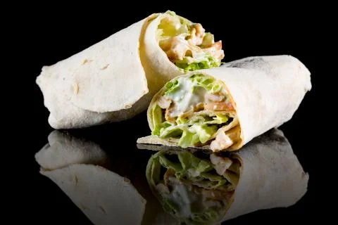 CHICKEN SALAD WRAP with reflection isolated on black background Stock Photos