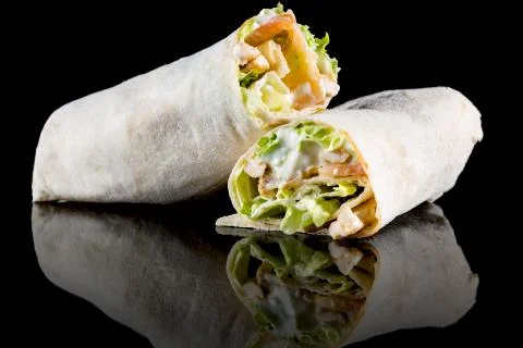 CHICKEN SALAD WRAP with reflection isolated on black background Stock Photos