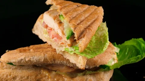 Chicken sandwich, close-up view, black background, loop Stock Footage 91035226