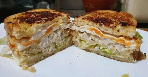 Chicken sandwich with egg split in half. Stock Photos