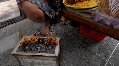 Chicken satay traders grilling and selling on the street Stock Footage 274647583