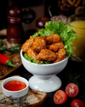 Chicken in sauce in a white bowl on the table Stock Photos