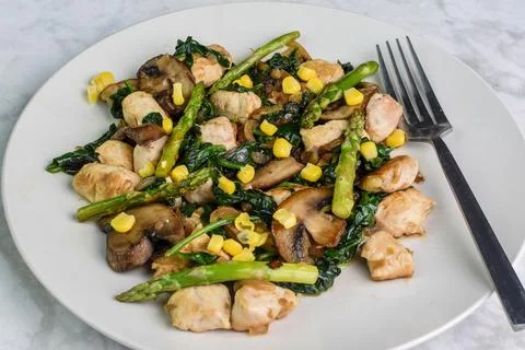 Chicken with sauteed vegetables Stock Photos