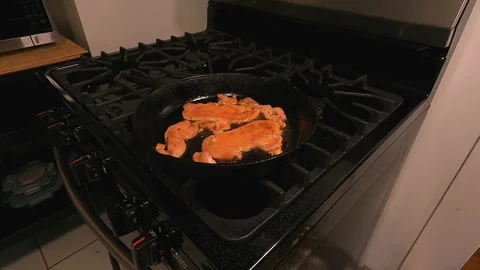 Chicken Sautéing in Cast Iron Skillet o... | Stock Video | Pond5