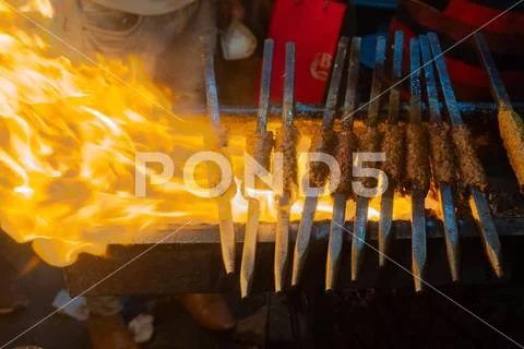 Chicken seekh kababs are being prepared road side Stock Photos