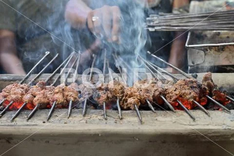 Chicken seekh kababs are being prepared road side Stock Photos