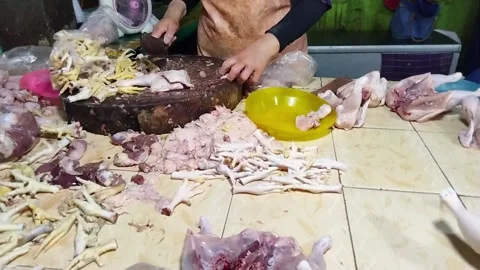 A chicken seller is cutting chickens to sell to buyers Stock Footage 242570904