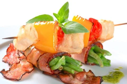 Chicken skewer and string beans wrapped in bacon Stock Photos
