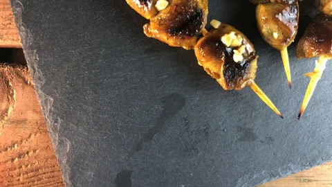 Chicken skewers on a dark background Stock Footage 128894384