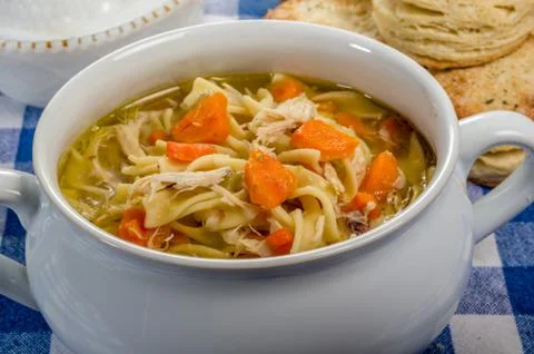 Chicken soup and biscuits on table Foto stock