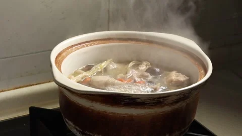 Chicken Soup Boiling in Clay Pot with Steam Slow Motion Stock Footage 340775346
