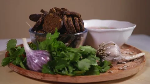 Chicken soup, bread crackers and vegetables on a wooden plate Stock Footage 124382656
