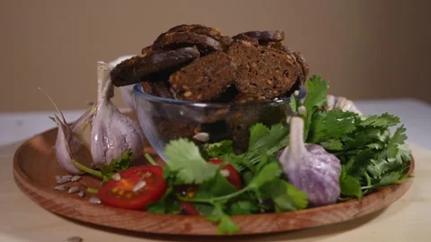 Chicken soup, bread crumbs and fresh greens on a wooden plate Stock Footage 124383308