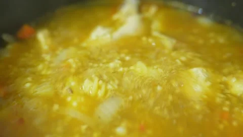 Chicken soup is cooked in a saucepan. Stock Footage 327857756