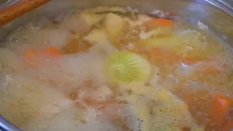 Chicken soup cooking in pot, close-up, food and cooking concept Stock Footage 334993099