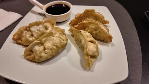 Chicken spring dumplings served on white plate with soya sauce pot  스톡 동영상 318578327