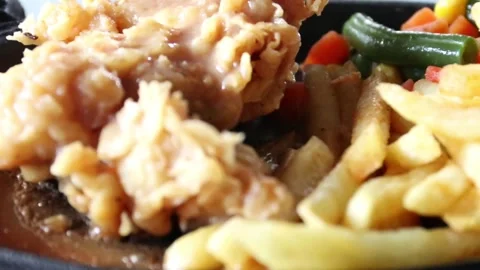 Chicken steak complemented by crispy fries Stockbeeldmateriaal 244014919