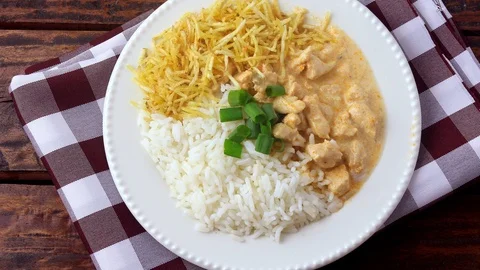 Chicken stroganoff, is a dish originating from Russian cuisine that in Brazil Stock Footage 112896306