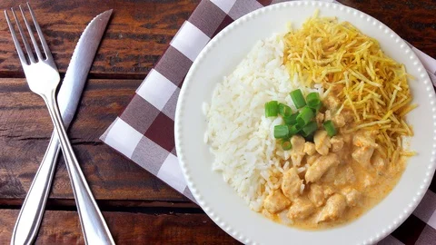 Chicken stroganoff, is a dish originating from Russian cuisine that in Brazil Stock Footage 112896322