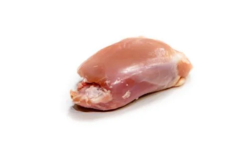 Chicken thigh fillet without bone and skinless, isolated with shadow. Stock Photos