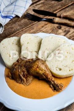 Chicken thigh on red pepper sauce Stock Photos