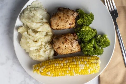 Chicken thighs  with broccoli and mashed  potatoes. Stock Photos
