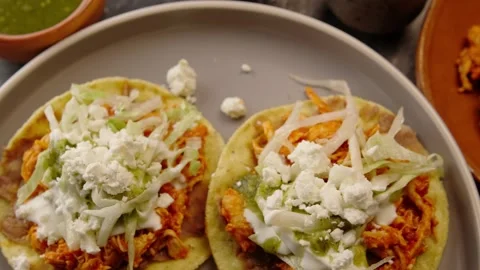 Chicken tinga tostadas on a round gray ceramic plate, top view Stock Footage 281392808