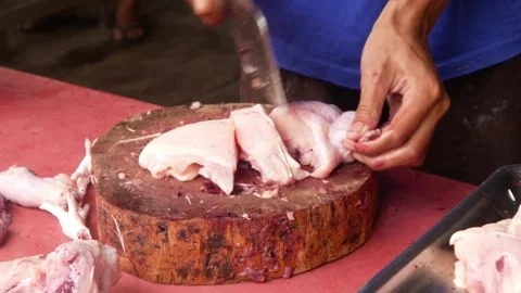 Chicken trader cutting up chicken meat Stock Footage 310248469
