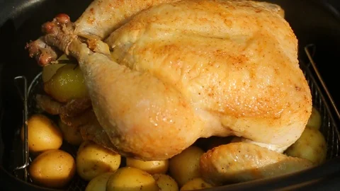 Chicken turkey over potatoes steaming hot. In pressure cooker Stock Footage 106828349
