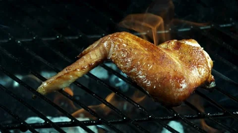 Chicken wing grilling over an open flame Stock Footage 327179884