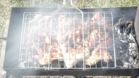 Chicken wings are cooked on the grill Stock Footage 159754531