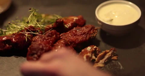 Chicken wings are cooked, lying on a plate in the restaurant, ready to eat. Stockbeeldmateriaal 241183000