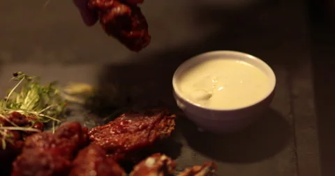 Chicken wings are cooked, lying on a plate in the restaurant, ready to eat. Stock Footage 241183371