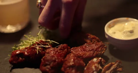 Chicken wings are cooked, lying on a plate in the restaurant, ready to eat. Stock Footage 241183865