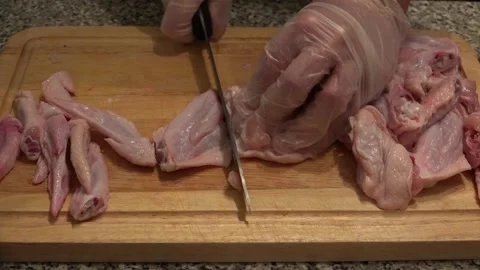 Chicken Wings being sliced in the kitchen Stock Footage 239638289