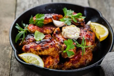 Chicken wings in cast iron skillet Stock Photos