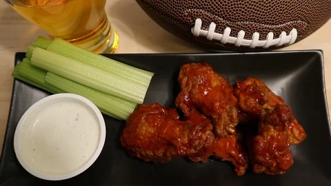 Chicken Wings Celery Blue Cheese Sauce and Beer for Watching Football Stock Footage 129581197