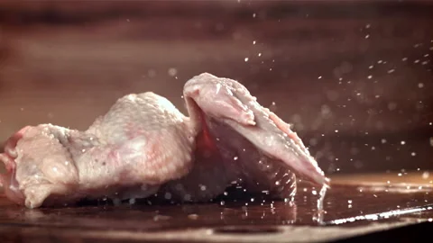 Chicken wings fall on a cutting board. Filmed on a high-speed camera at 1000 fps Stock Footage 263272888