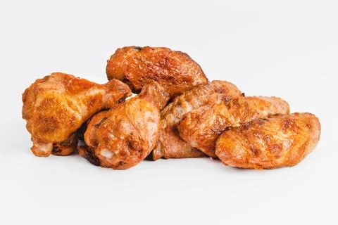 Chicken wings fried until half cooked, semi-finished product with fresh herbs on Stock Photos