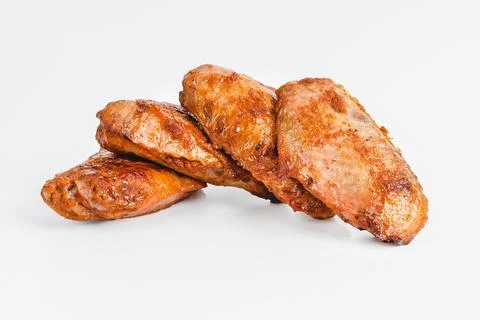 Chicken wings fried until half cooked, semi-finished product with fresh herbs on Stock Photos