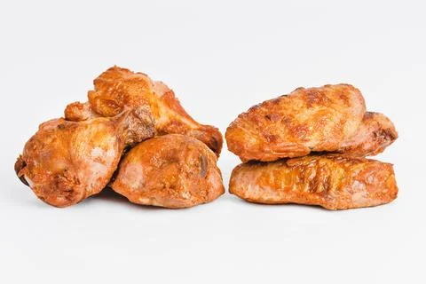 Chicken wings fried until half cooked, semi-finished product with fresh herbs on Stock Photos
