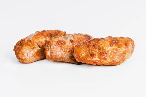 Chicken wings fried until half cooked, semi-finished product with fresh herbs on Stock Photos